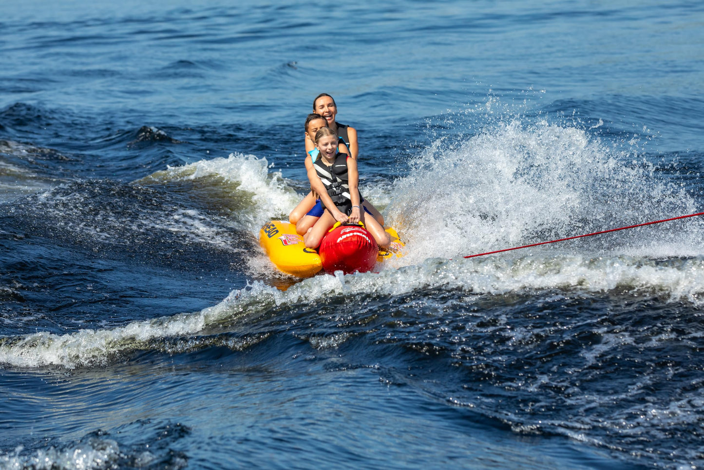 Airhead Hot Dog Towable Tube for Boating, 1 - 3 Rider Inflatable Boat Tube for Water Tubing, Full Nylon Cover, EVA Padding, Foam Padded Handles w/ Neoprene Knuckle Guard, Speed Safety Valve
