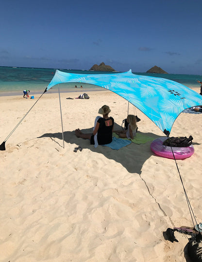 Neso Portable Beach Tent Sun Shelter with Sand Anchor - Lightweight Beach Shade Canopy - Easy Setup for Family Outings - Patented Reinforced Corners - UPF 50+ Sun Protection - 7 x 7ft - Aqua Fronds