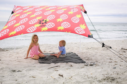 Neso Portable Beach Tent Sun Shelter with Sand Anchor - Lightweight Beach Shade Canopy - Easy Setup for Family Outings - Patented Reinforced Corners - UPF 50+ - 7 x 7ft - Pineapples